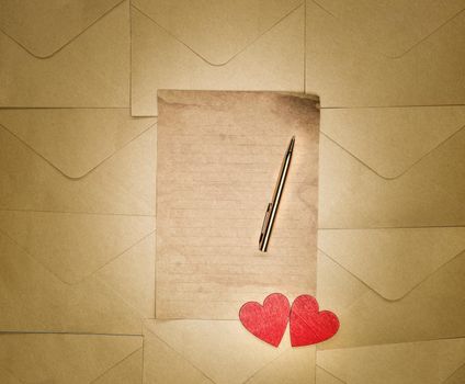 Love letter with red Hearts and Vintage antique paper with Copy space top view, romantic, Valentines day, love concept background gold pen