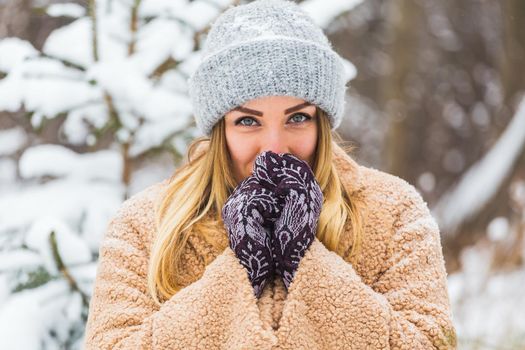 Attractive young woman in winter time outdoor. Snow, holidays and season.