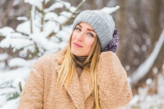 Attractive young woman in winter time outdoor. Snow, holidays and season.