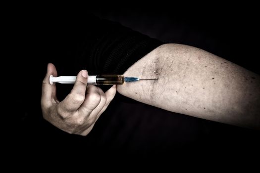 heroin addiction Junky shooting up Horse with syringe on dark background, Drugs,Junk,teen,addict concept portrait