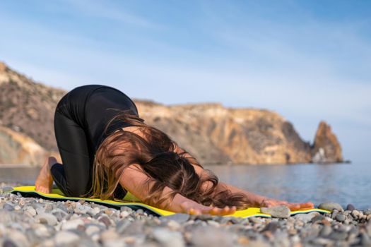 Group of young womans fitness instructor in Sportswear Leggings and Tops, stretching in the gym before pilates, on a yoga mat near the large window on a sunny day, female fitness yoga routine concept.