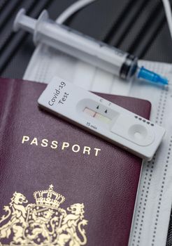 COVID-19, travel and lockdown concept,Passport with Covid-19 rapid test and syringe for vaccination Coronavirus. Traveling requirement flying holiday