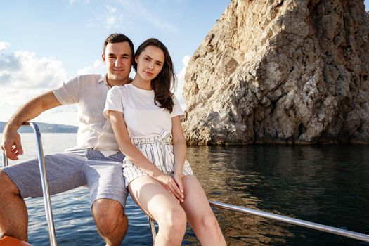 Happy couple in love on a yacht in summer on romantic vacation