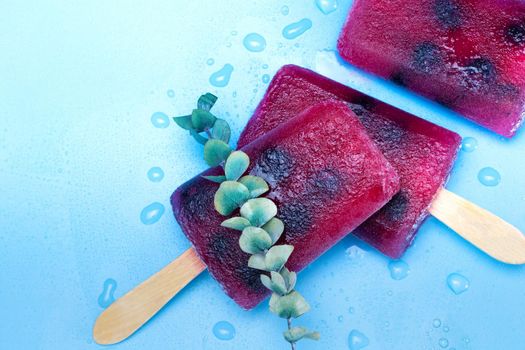 Homemade Raspberry and blueberry ice cream top view on blue background summer, desser,food concept modern design with copy space colorful ice style
