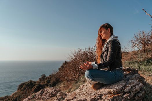 woman traveler drinks coffee with a view of the mountain landscape. A young tourist woman drinks a hot drink from a cup and enjoys the scenery in the mountains. Trekking concept