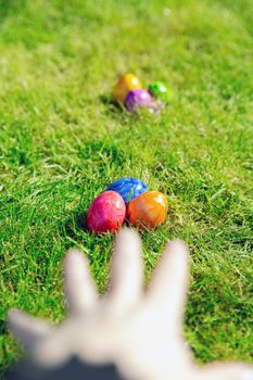 Easter eggs hidden in the grass, Colorful handmade painted Easter eggs hunt, Happy Easter Holiday concept in garden or park,spring