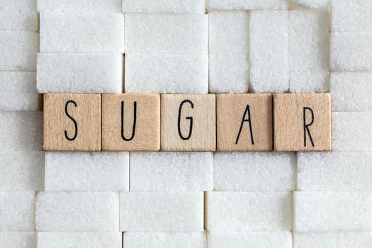 Sugar cubes wall with the text Sugar on brown natural background texture, Health,diabetes,medical,sugar,sweet.junk food concept copy space