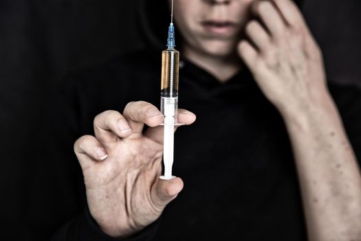 heroin addiction Junky shooting up Horse with syringe on dark background, Drugs,Junk,teen,addict concept portrait