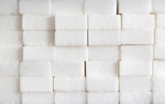 White sugar cubes composition of Brick wall, pile of sugar, unhealthy food, ingredient, candy and sweets closeup
