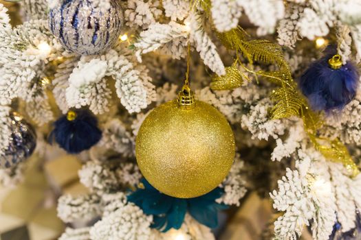 Christmas-tree decorations on a christmas fir-tree. Holidays and decor.