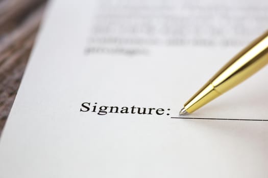 Signing a contract with signature with gold pen macro close-up, businessman,contract,deal,concept background loan,mortgage or eployment