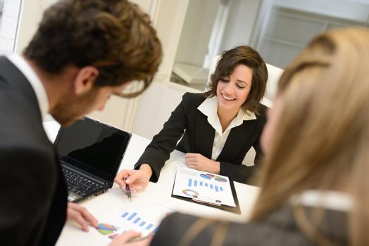 Image of business partners discussing documents and ideas at meeting. Woman leader wearing blazer