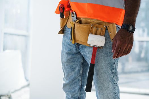 Close up photo of unrecognizable man foreman in workwear on construction site