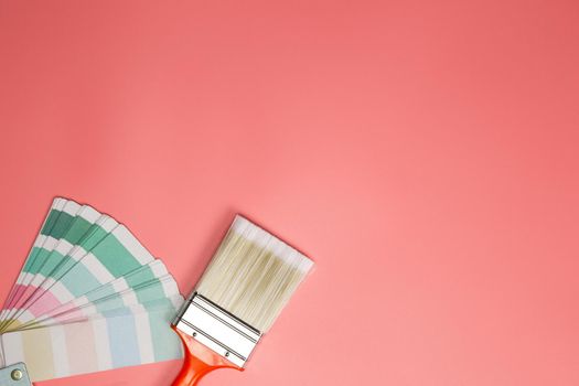 Paintbrush with palette for painting sample with pastel colors on pink background top view, Flat lay,copy space, home,concept background space for text