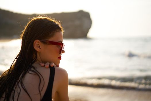 woman in a black swimsuit on the beach sea Summer vacation. High quality photo