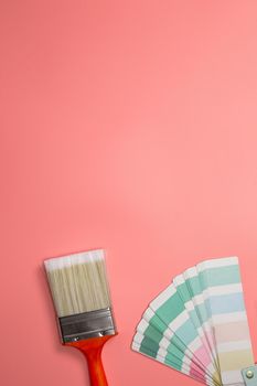 Paintbrush with palette for painting sample with pastel colors on pink background top view, Flat lay,copy space, home,construction,decoration,business concept background space for text