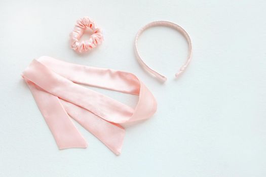 silk pink rounded hairband isolated on white. Flat lay Hairdressing tools and accessories as Hair Scrunchie, Elastic Hair Bands, Bobble Scrunchie Hairband square image