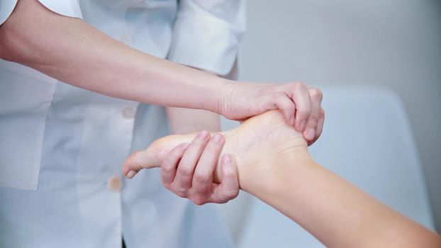 Massage - massage master is kneading womans feet - indoor