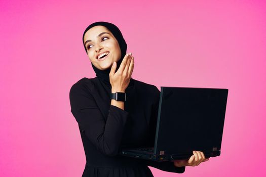 cheerful muslim woman with laptop education student internet technology. High quality photo