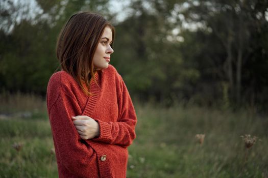 pretty woman in red sweater outdoors walk leisure. High quality photo