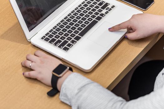 set of modern computer devices - laptop, watch and phone close up