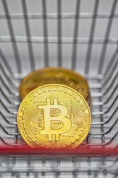 Gold Bitcoin is a cryptocurrency and worldwide payment, Bitcoin, Ethereum, Litecoin in iron shopping basket, Virtual money concept. close up business and financial concept