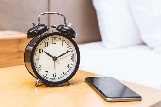 Alarm clock on the desk beside of bed