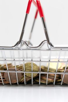 Iron shopping basket filled with euro coins isolated on white background, business and financial concept