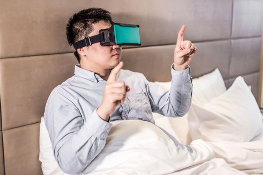 man wear vr glasses in the bed