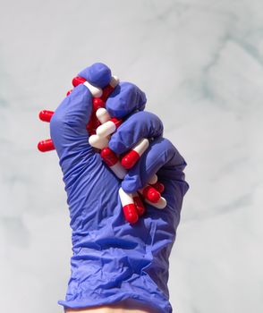 A hand grabbing hand full of medicines, Capsules for Vitamines,drugs,medication. Health,business concept background copy space