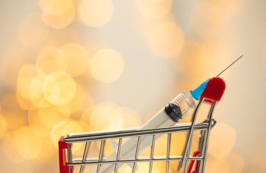 syringe injection in shopping cart for coronavirus vaccine disease, covid-19 or other virus, vaccination shot, medicine and drug concept bokeh background health