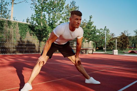 man doing exercises outdoors on the playground. High quality photo