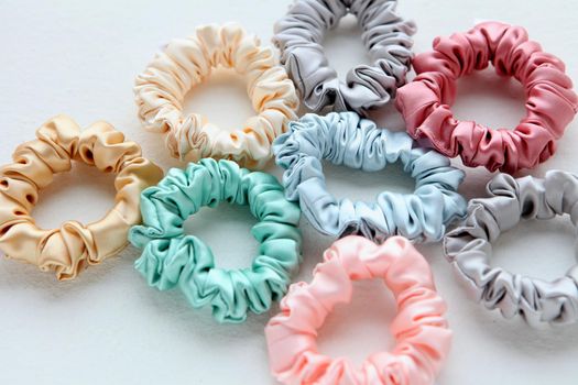 Lot of Colorful silk Scrunchies isolated on white. Flat lay Hairdressing tools and accessories. Hair Scrunchies, Elastic HairBands, Bobble Sports Scrunchie Hairband