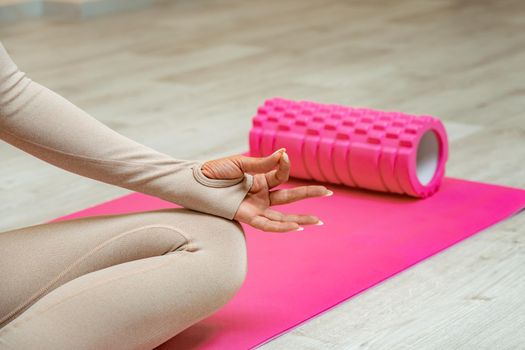 Close up hand and half body of healthy woman sit in lotus Yoga position.Young healthy woman sitting posture exercise in home.Concept of meditating,lifestyle and relaxation