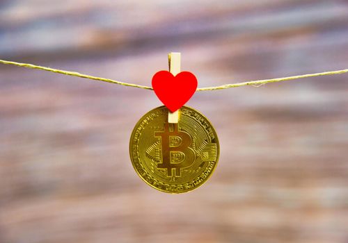Bitcoin hanging with red heart isolated on white background.Coins for business sell and trade. Bit coin Mining or block chain technology for crypto currency. Modern electronic money for virtual exchange. Valentine