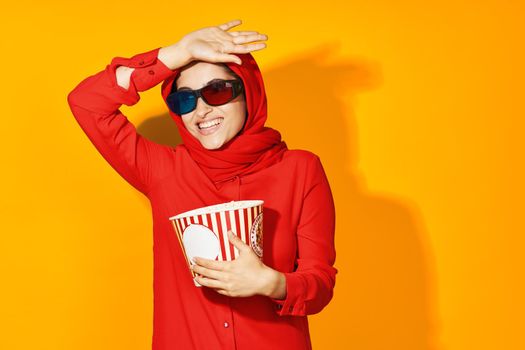 woman in red hijab popcorn entertainment cinema ethnicity model. High quality photo