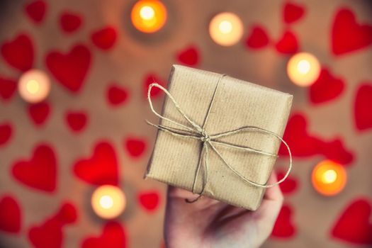 Hands holding beautiful gift box, female giving gift, Valentine's Day, holidays and greeting season concept, top view background romantic design