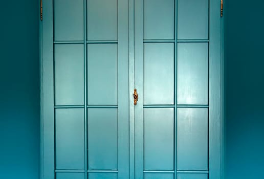 Cyan blue wall with cupboard stylish interior,modern blue cupboard door background texture beautiful luxury house decoration closeup