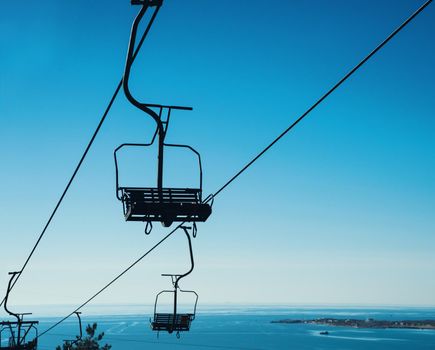 Cableway on background of blue sky, cableway funicular chair equipment, no people
