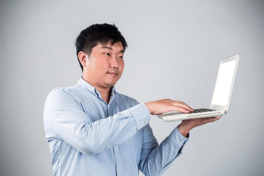 Business man with a laptop - isolated over a white background