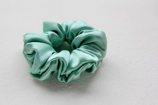 turquoise silk Scrunchy isolated on white background. Flat lay Hairdressing tool of Colorful Elastic Hair Band, Bobble Sports Scrunchie Hairband