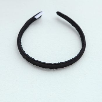 black silk hair hoop. silk ribbon isolated on white. Flat lay Hairdressing tools and accessories as Orbital Hair ring or hair hoop