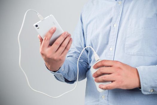 man is charging smartphone good