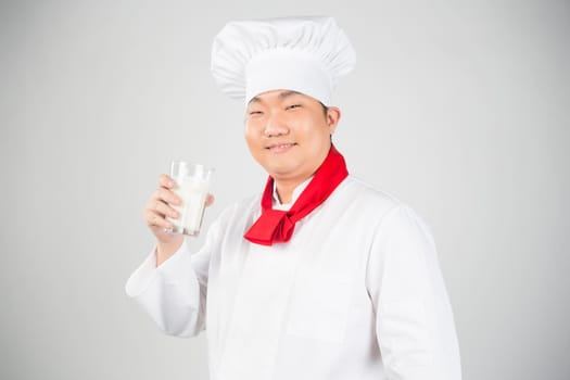 chef holding glass cup and drink yogurt or milk nice photo
