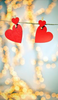 Happy Valentine day background with red hearts hang with clothespin on rope with bokeh background, romantic design, greeting card or copy space space for text