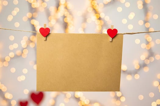 Blank letter, envelope or greeting card hanging with red hearts, romantic love letter , Valentines Day concept bokeh background, copy space romantic design