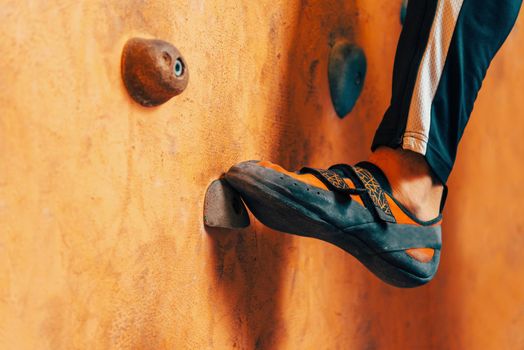Close-up image of male foot on climbing wall