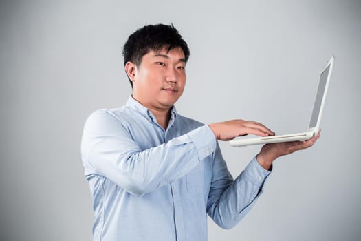 Business man with a laptop - isolated over a white background