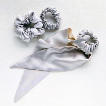 silver silk Scrunchy on white. Flat lay Hairdressing tools and accessories. Color Hair Scrunchies, Elastic Hair Bands, Bobble Sports Scrunchie Hairband