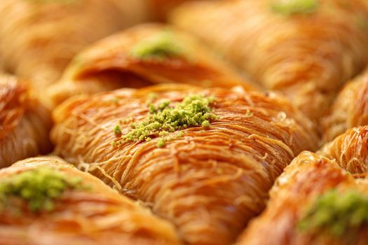 Close up photo of Turkish Baklava dessert with honey and nuts